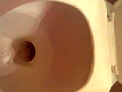 Hairless pussy caught on bathroom camera urinating