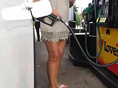 Hotwife Trina shows off her upskirt while pumping gas in teasing video